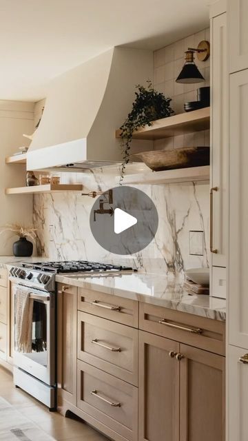 Interior Alchemy - Interior Design Inspiration on Instagram: "This stunning kitchen effortlessly blends elegance and functionality. The marble backsplash and countertops add a touch of luxury, while the warm wood cabinetry brings a cozy feel. The floating shelves and sleek brass hardware offer modern sophistication. A pot filler above the stove is both practical and stylish. For a similar look, consider incorporating open shelving to display your favorite decor and opt for a neutral color palette to keep the space bright and inviting ✨🤍  Save for later!  #KitchenDesign #InteriorInspo #MarbleBacksplash #ModernKitchen #WarmInteriors #HomeDecor #DesignIdeas #LuxuryLiving #KitchenGoals #interioralchemyhq  @natcaronphoto" Marble Open Shelves Kitchen, Open Shelves By Stove, Open Shelves Around Kitchen Window, Vent Hood With Open Shelves, Kitchen Backsplash Above Stove, Stove Area Ideas Kitchen, Hood With Open Shelving, Hood With Floating Shelves, Range Hood With Open Shelving