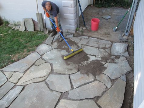 Spreading the sand between flagstones. Diy Stone Patio, Flagstone Patio Design, Flagstone Pathway, Flagstone Pavers, Flagstone Walkway, Flagstone Path, Building A Patio, Backyard Walkway, Flagstone Patio