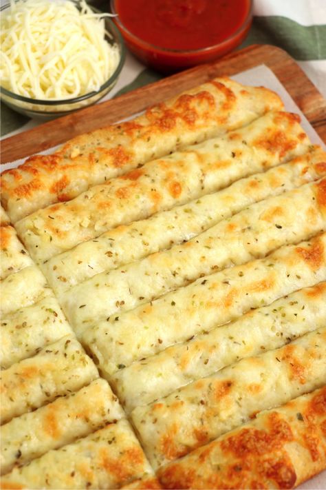 Homemade Cheese Sticks - Delicious garlic pizza crust breadsticks brushed in buttery garlic and layered with cheese. Melty, bubbly, cheesy perfection! Quick Cheesy Breadsticks, Pizza Crust Garlic Cheese Bread, Garlic Cheese Sticks With Pizza Crust, Cheesy Pizza Sticks, Pizza Bread Sticks Recipe, Pizza Crust Cheese Bread, Cheesy Breadsticks Pillsbury, Cheesy Garlic Sticks, Garlic Cheese Pizza Bread