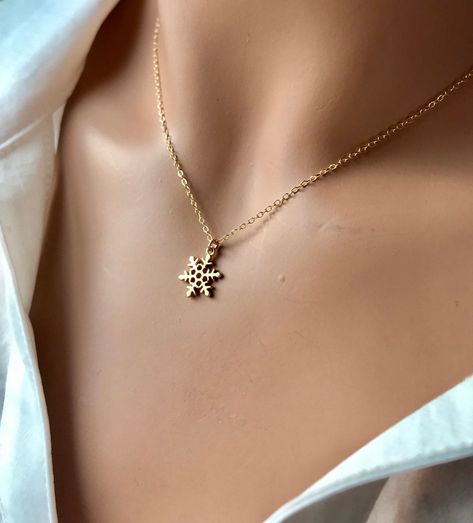 A dainty snowflake charm necklace.  Delicate in style yet Sturdy for everyday wear.   Materials: High quality Gold plated Brass, 14k gold filled chain or gold plated chain. Your purchase comes in a beautiful box that is ready to give as a gift or to keep for yourself. **Want a custom design?  Just ask! The custom made jewelry is sure to make the owner feel like a super star.  We love mixing finishes.  **Please be sure to read my shop policies and shop announcement before making your purchase. Tiny Snowflake, Frozen Snowflake, Snowflake Necklace, Amazonite Necklace, Bride Jewelry, Sterling Silver Initial, Card Tricks, Gold Bride Jewelry, Kids Necklace