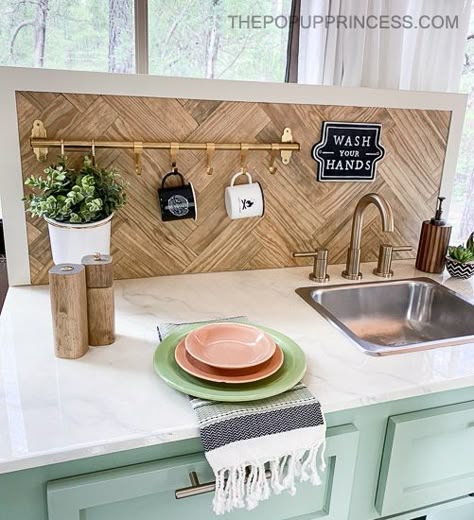 Transform your pop up camper with a simple, yet functional, backsplash. All you need is a few boards and some sash locks to complete the project. Boho Pop Up Camper, Pop Up Camper Interior Ideas, Pop Up Camper Storage Ideas, Camper Backsplash, Pop Up Camper Organization, Pop Up Camper Storage, Vintage Camper Renovation, Pop Up Kitchen, Pop Up Camper Remodel