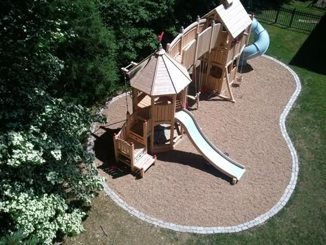 borders for pea gravel | Wooden playset with pea gravel and border Playground Architecture, Playset Landscaping, Playground Landscaping, Backyard Kids, Backyard Playset, Backyard Structures, Gravel Landscaping, Play Area Backyard, Backyard Kids Play Area