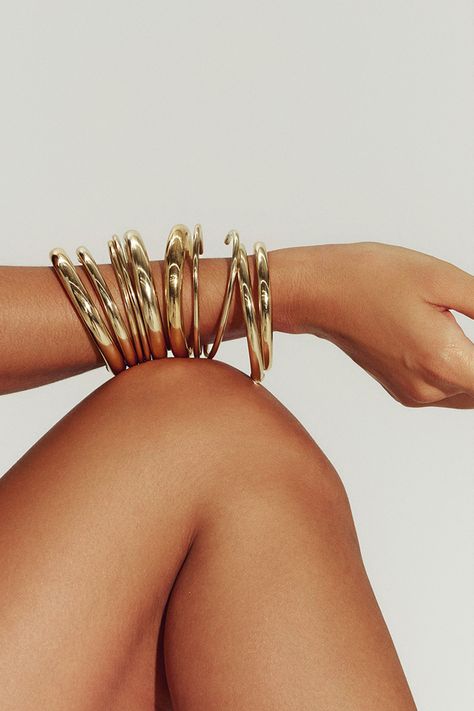 Filled with 18K gold, our Brazil-made tube cuff is the dynamic final touch – or the gleaming foundation of a sculptural bracelet stack. Mix in varying widths and finishes for the most impact. Jewelry Collection Handcrafted in Brazil 18K Gold Filled Thickness: 8.4mm Inner Diameter: 2.5" Opening: 1.25" Weight: 0.38 oz Waterproof Hypoallergenic Large Gold Jewelry, Gold Hoop Bracelet, Jewelry Stack Aesthetic, Thick Gold Jewelry, Jewelry Stacks Gold, Gold African Jewelry, Big Gold Jewelry, Stacked Gold Jewelry, Sculptural Bracelet