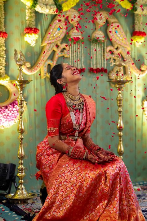 Photo of Bride playing with flower petals. Red Kanjeevaram Saree, Hyderabad Wedding, Photo Of Bride, Indian Bride Poses, Half Saree Function, Indian Bride Photography Poses, Bridal Sarees South Indian, Indian Bridal Sarees, Wedding Lehenga Designs