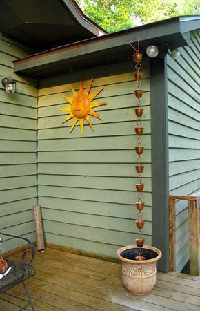 Source: Randy and Meg’s Garden Paradise The large decorative pot at the foot of this rain chain serves as an intriguing visual contrast to the sleek copper buckets that make up the chain. This interplay of metal and ornate ceramic provides timeless style. Rain Chain Diy, Greenhouse Decor, Backyard Vacation, Rain Chains, Garden Paradise, Drain Pipe, Rain Chain, Rain Barrel, Rain Water Collection