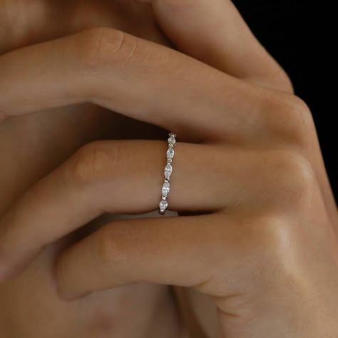 Our minimal marquise eternity band features 7 shimmering stones set sideways halfway around the ring. The delicate design of the band creates an elegant and timeless feminine look. It looks stunning as a wedding band on its own, or stacked with other rings as a statement piece. Each piece is made in sterling silver and dipped in White Gold (Rhodium) for extra shine and durability. Dainty Wedding Band White Gold, Simple Wedding Bands For Women Silver, Diamond Wedding Bands White Gold, Wedding Bands White Gold, Marquise Eternity Band, Wedding Bands Silver, Minimal Wedding Band, Marquise Band, Bc Wedding