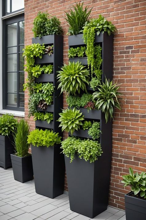 Add instant height and visual interest to your garden with these 20 tall planter ideas for vertical gardens. Whether you're working with a small space or just want to create a unique focal point, these planters are a great way to add some extra greenery to your outdoor space. Click here to see all 20 ideas. Decorative Hanging Baskets, Vertical Garden Plants, Wall Gardens, Tall Planter Ideas, Wall Plants, Garden Wall Designs, Potted Plants Outdoor, Vertical Garden Wall, Tall Planters