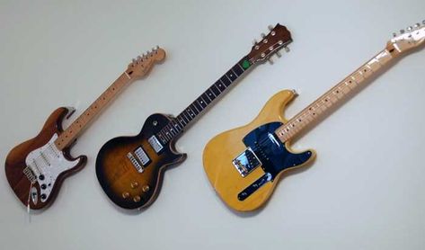 Guitar Hangers Wall, Hang A Guitar On The Wall Diy, Wall Mounted Guitars, Wall Hanging Guitar, Hang Guitars On Wall Ideas, Ways To Hang Guitars On Wall, How To Hang A Guitar On The Wall, Guitar Wall Hanger Ideas, Hanging Guitars On Wall Ideas