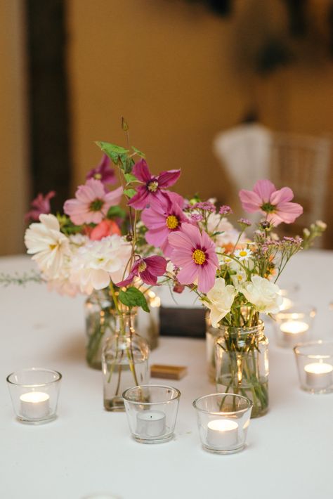 Delicate individual flowers in a glass jar act as simple yet elegant table centrepieces #myrescastle #barnquee #wedding photo by Photos by Zoe Wedding Table Jars Flowers, Wildflowers In Small Vases, Glass Jar Table Centerpieces, Jam Jar Flowers Centerpieces, Flowers In Jam Jars, Dainty Wedding Flowers Table, Glass Jar Flower Arrangements, Small Table Bouquet, Jam Jar Wedding Flowers