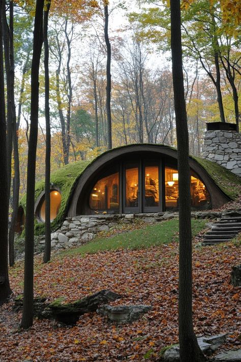 Modern forest house hobbit style earth sheltered facade. Check out all of these creative forest houses that blend rustic charm with modern elegance, making the woodland retreat truly unique. Earthen House Natural Building, Unique House Plans Modern, Modern Hobbit House, In Ground House, Modern House Nature, Earth Homes Underground, Hobbit Architecture, Hobbit Inspired House, Small Forest Cabin