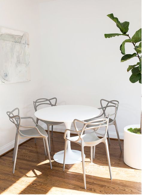 Contemporary dining space features a white Ikea Docksta Table surrounded by four gray Masters Chairs sat on wood floors holding a potted plant and contrasting white walls accented with a white and gray abstract art piece. Ikea Docksta Table, Ikea Docksta, Docksta Table, Masters Chair, Dining Room Contemporary, Dinning Set, Ikea Chair, Contemporary Dining Room, Contemporary Dining