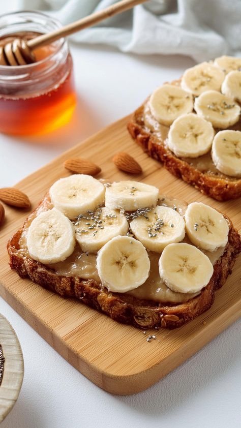 Looking for some healthy breakfast toast ideas? Try this Almond Butter Banana Honey Toast recipe! The sweetest easy way to start your mornings. It features whole-grain toast topped with creamy almond butter, fresh banana slices, a drizzle of honey (or agave for a vegan option), and a sprinkle of chia seeds for added nutrition. This combination is both satisfying and nutritious. Banana With Honey, Honey Toast Recipe, Banana And Almond Butter, Breakfast Toast Ideas, Almond Butter Toast, Healthy Toast Toppings, Whole Grain Toast, Banana Almond Butter, Healthy Breakfast Toast