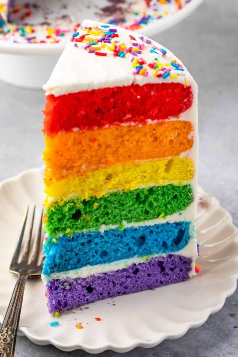 The perfect Rainbow Cake recipe starts with a cake mix and has homemade frosting. No one will know this cake is semi-homemade and it's the perfect rainbow colors for any rainbow party! Simple Rainbow Cake, Diy Rainbow Cake, Rainbow Birthday Cakes, Rainbow Food Recipes, Rainbow Cake Designs, Rainbow Cake Ideas, Desserts Photos, Unicorn Rainbow Cake, Pretty Baking