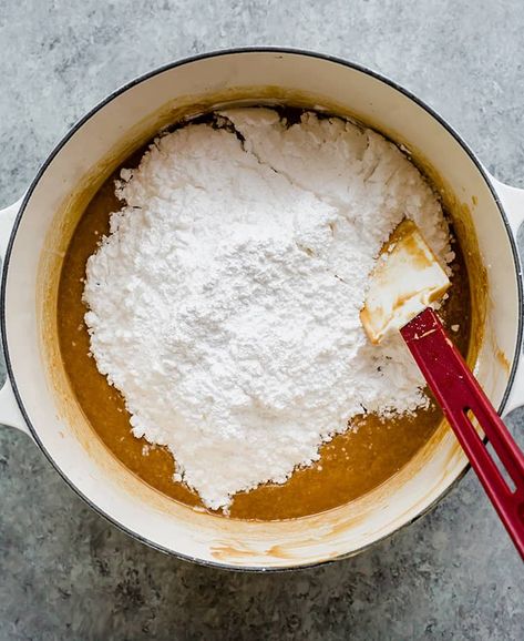 Pot of melted butter and peanut butter with powdered sugar being mixed in. Peanut Butter Meltaway Fudge, Easy Peanut Butter Fudge With Icing, Small Batch Peanut Butter Fudge, Chocolate Peanut Butter Fudge With Sweetened Condensed Milk, Peanut Butter Fudge With Evaporated Milk, Peppermint Marshmallows Recipe, Easiest Peanut Butter Fudge All Recipes, Powdered Sugar Recipes, Fudge With Condensed Milk