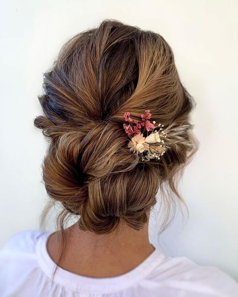 Wedding Updos 2023 Guide: 50 Best Looks, Expert Tips & FAQs Wedding Hair Updo Low Bun, Boho Upstyles Wedding, Low Bun Flowers, Wedding Updo Flowers, Bohemian Wedding Updo, Low Wedding Updo, Bride Hair Bun, Wedding Bun Hairstyle, Orange Weddings