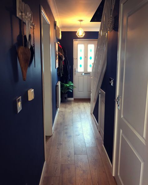 Finished hallway, oak flooring, navy walls, white woodwork #darkdecor Navy And Grey Hallway Ideas, Small Dark Entrance Hall Ideas, Hallway Ideas Navy, Navy Blue Hallway Ideas, Blue Entrance Hall, Dark Blue Hallway Ideas, Navy Blue Hallway, Navy Hallway Ideas, Dark Blue Hallway