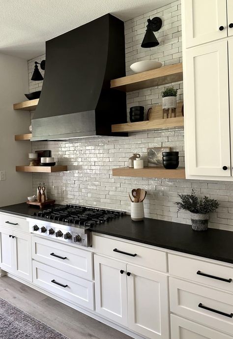 White Kitchen Cabinets Black Countertops Herringbone Backsplash, Black Kitchen Cabinets With Floating Shelves, Kitchen Remodel With Dark Countertops, Black Hoods In Kitchens, White Kitchen Black Counter Granite, Moody White Kitchen, White Black Kitchen Ideas, Pantry Black And White, White Kitchen Black Accents