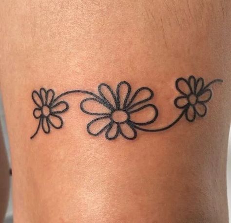 130+ Daisy Tattoo Ideas To Put A Smile On Your Face Daisy Anklet Tattoo, Fine Line Daisy Chain Tattoo, Simple Flower Tattoo Ideas, Daisy Finger Tattoo, Daisy Tattoo Ideas, Daisy Chain Tattoo, Small Daisy Tattoo, Tattoo Ideas Simple, Cute Foot Tattoos