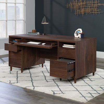 Feel like a true executive when seated at this elegant, mid-century modern executive desk from the Emriye collection. With the clean lines and organic color that were a staple in mid-century design, youll find the executive pedestal desk the perfect addition to your home office. Hidden behind a flip-down panel youll find access to the modern amenities of mouse and keyboard that are disguised by stylish panel for a pleasing aesthetic when not in use. Two file drawers with full extension slides h… Home Office Hidden, Room Placement, Pleasing Aesthetic, Modern Executive Desk, Double Pedestal Desk, Cottage Bath, Drawer Shelf, Pedestal Desk, Mouse And Keyboard