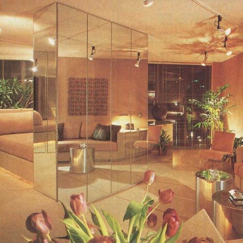 #TBT  The epitome of style in 1982, this floor-to-ceiling mirror setup was believed to give the feeling of more space, and also hid cabinetry and an entertainment center.  You might notice the angled lighting created a dramatic effect and helps point your eyes where the interior designer wanted you to focus.  #UnitedRealEstateChicago #RealEstate #RealEstateForSale #RealEstateExpert #CreditRepair #CreditRepairman #Homes #Chicago #GlenEllyn #GlendaleHeights #Wheaton #CarolStream #Bloomingdale 80s Living Room, 1980s Interior Design, 1980s Interior, 90s Interior, 80s Interior Design, 80s House, 80s Bedroom, 80s Home, 90s Home