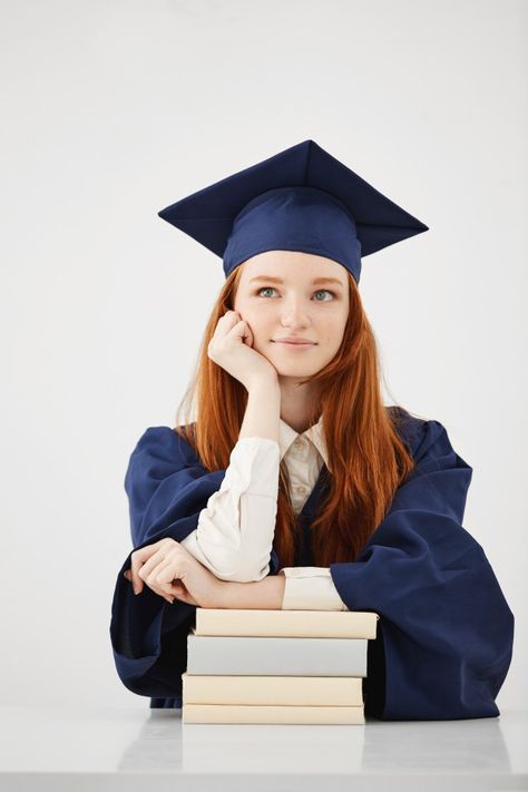 Dreamy graduate woman smiling thinking sitting with books over white surface Free Photo Successful Student Photo, Graduation Photoshoot With Books, Education Graduate Pictures, Graduate Studio Photoshoot, Grad Photos With Books, Graduation Pictures Indoor, Graduation Shoot Studio, Graduation Photos Studio, Graduation Photoshoot Indoor