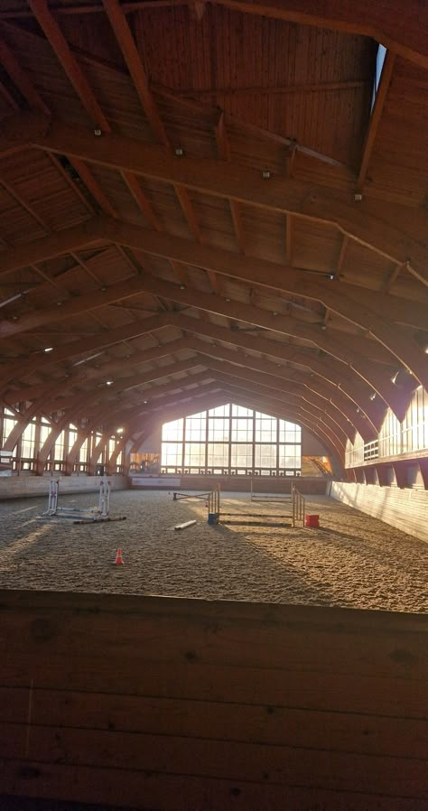 Indoor horse show jumping practice arena during sunset in a stable Indoor Jumping Arena, Show Jumping Wallpaper, Show Jumping Arena, Stable Hand Aesthetic, Small Indoor Arena, Horse Stables Aesthetic, Horse Jumping Arena, Indoor Arena Horse, Stables Aesthetic