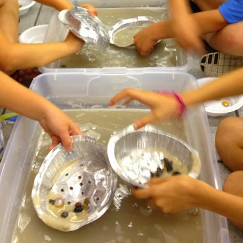 Panning for Gold activity- 1 bag of play sand, small aluminum pie pans (poke holes in the bottom), 4 tubs, shiny gold glass beads and dull gold glass beads.. Dont put as many dull golds beads and make them 3g and the shiny ones 1g, can incorporate math lesson and see how much $$ students made Pan For Gold Activity, Panning For Gold Activity For Kids, Gold Mining Birthday Party, Wild West Science Activities, Gold Mine Decorations, Gold Rush Activities, Mining Birthday Party, Gold Rush Party, Wild West Activities