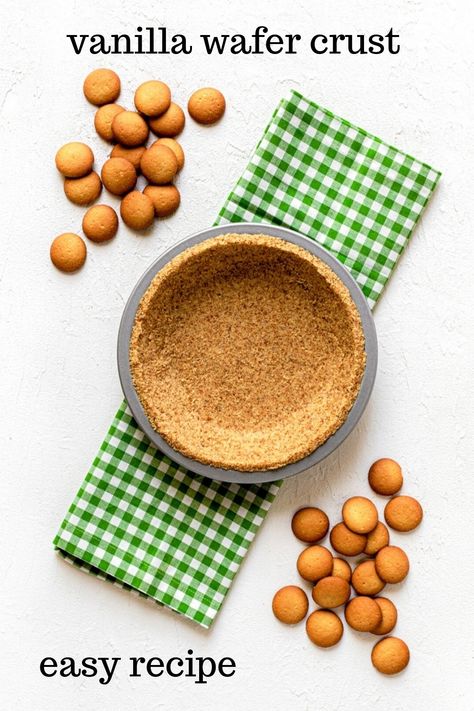 A vanilla wafer crust (AKA: Nilla wafer crust) in a metal pie pan. The pan is atop a green/white cloth gingham napkin. Also in the image is a double scattering of vanilla wafer cookies. This is an overhead image. The background is bright white. Vanilla Wafer Pie Crust Recipe, Vanilla Wafer Pie Crust, Nilla Wafer Crust, Cookie Crumb Crust, Banana Pudding Ingredients, Old Fashioned Banana Pudding, Vanilla Wafer Crust, Crumb Crust, Pie And Tart