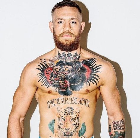 McGregor's chest tattoo is one of his most renowned tattoos in the tattoo industry. The tattoo portrays an enraged gorilla devouring a heart, representing the savage personality he has. The tattoo design was inspired by the gorilla logo of the Straight Blast Gym-Ireland, where McGregor used to train. Conor Mcgregor Haircut, He Man Tattoo, Conor Mcgregor Tattoo, Conor Mcgregor Wallpaper, Conner Mcgregor, Mcgregor Wallpapers, Bodybuilding Tattoo, Connor Mcgregor, Gorilla Tattoo