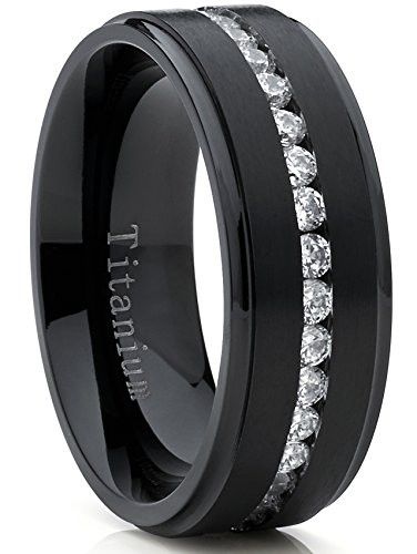 This new and innovative black plated ring is 8MM in width and comfort fit. It is high-polish with a matte finish raised center and has channel set round cut cubic zirconia going all the way around the ring. Our rings are hypoallergenic. All rings come with a 100% money back guarantee and a FREE ring box. Known for its superior strength, titanium is the metal of choice for those who desire a band that is both lightweight and durable. It is very strong and more scratch resistant than gold, silver Mens Eternity Wedding Bands, Wedding Bands Black, Trending Rings, Mens Wedding Bands Black, Black Titanium Ring, Wedding Band Ideas, Men Wedding Band, Titanium Rings For Men, His Ring