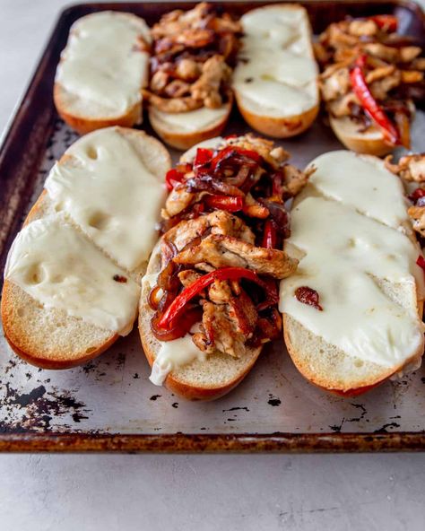 Thinly sliced chicken sizzled in a hot skillet, topped with sauteed sweet bell peppers and onions, covered in melted American cheese, and served on a soft toasted Hoagie roll…it’s easy to see why a Chicken Philly Cheesesteak is always a crowd-pleaser. #sandwich #philly #cheesesteak #familyfriendly #dinner #easyrecipe #chicken Chicken Pepper Sandwich, Chicken Philly Cheesesteak Recipe, Chicken Hoagie, Hoagie Roll Recipe, Chicken Peppers And Onions, Philly Cheesesteak Sandwiches, Philly Cheesesteak Recipe, Chicken Philly Cheesesteak, Philly Sandwich