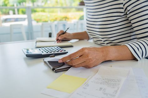 Woman with bills and calculator. woman using calculator to calculate bills at the table in office. calculation of costs. Premium Photo Table In Office, Accounting Firms, Accounting Services, At The Table, Photo Editing Software, Premium Photo, The Table, 1 Million, Calculator