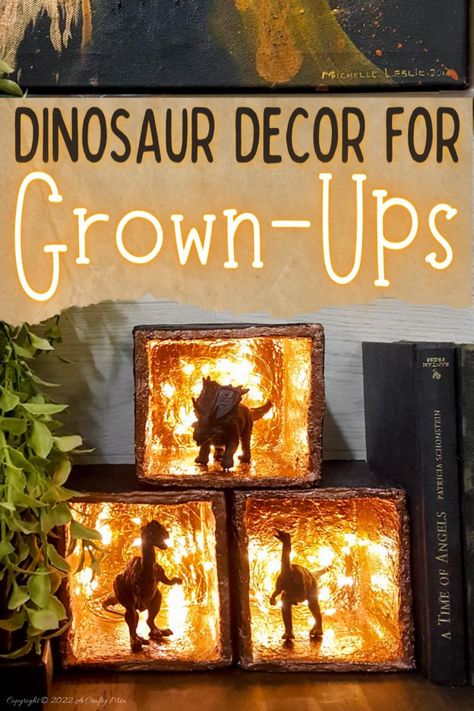 Did your son or daughter collect prehistoric creatures when they were younger? We had a whole drawer full, so when my son moved into his own apartment, I decided to repurpose those plastic toys into fun dinosaur décor for grown-ups. This tutorial will show you how it’s done. #ACraftyMix Diy Dinosaur Classroom Decor, Diy Dinosaur Toy, Plastic Dinosaur Crafts, Dinosaur Crafts For Adults, Dinosaur Birthday Diy Decorations, Dinosaur Room Ideas Diy, Dinosaur House Decor, Diy Dinosaur Decor Bedroom, Dinosaur Living Room