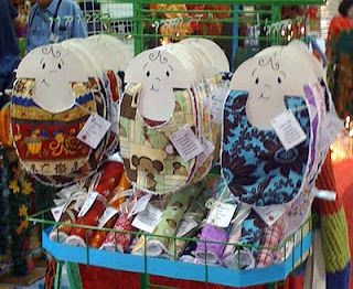 Interesting idea to help bibs lay flat for craft show display. Bib Display Craft Show, Lavender Lollipops, Craft Show Jewelry Display, Bib Packaging, Bib Display, Craft Stall Display, Craft Fair Booth Display, Craft Show Booths, Craft Show Booth