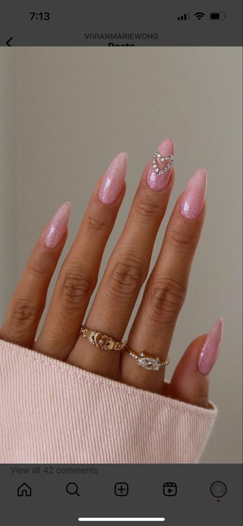 Pink glitter almond shaped nails with bedazzled heart jewels Sparkly Nails Acrylic Almond, Pink Heart Rhinestone Nails, Blush Pink Nails Prom, Pink Nails With Jewels Rhinestones, Pink Nails Acrylic Birthday, Long Nail Designs Pink Glitter, Pink Glitter Nails With Gems, Pink Nails Jewels, 18th Birthday Nails Ideas Simple