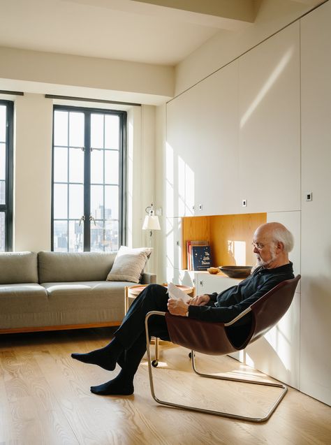 Resident Paul Andersson lounges in a Paulistano armchair by Paulo Mendes da Rocha. Blu Dot Sofa, Storage Coffee Tables, Light Hardwood, Light Hardwood Floors, Table Lighting, Lamps Table, Tiny Studio, Living Room Chair, Apartment Architecture