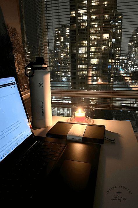 An open laptop on a desk beside a candle and planner with a nighttime cityscape in the background. Working Late At Night Aesthetic, Night Office Aesthetic, Night Time Routine Aesthetic Photos, Writing At Night Aesthetic, Early Adulthood Aesthetic, College Night Aesthetic, Working At Night Aesthetic, Night Time Study Aesthetic, Late Night Studying Aesthetic Motivation