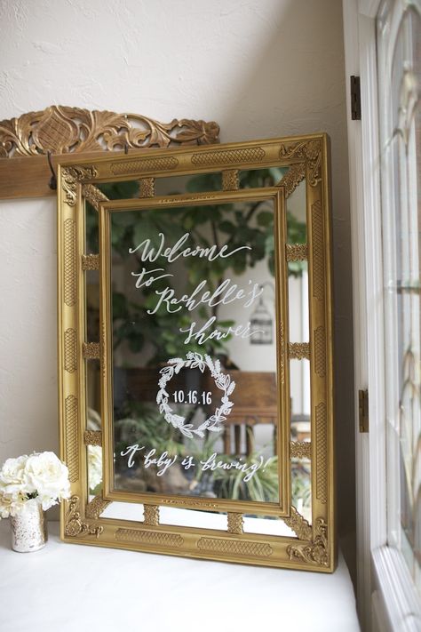 Stunning gold framed mirror with ornate detailing. Hand painted shower sign with wreath. A baby is brewing!  Custom welcome mirror. Mirror Bridal Shower Sign, Welcome Baby Signs, Baby Shower Oso, Baby Shower Pictures, Sprinkle Shower, Painting Shower, Gold Framed Mirror, Bridal Shower Sign, Baby Shower Brunch