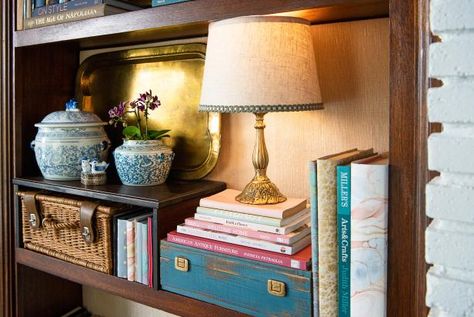 45 Built-in Bookshelf Decor Ideas | How to Style a Bookshelf | HGTV Lamp On Bookcase, Lamp In Bookshelf, Bookcase Lighting Ideas Built Ins, Cabin Bookshelves, Lamp On Bookshelf, Built In Bookshelves Decor, Bookshelf Lamp, Bookshelf Accessories, Tabletop Lamp