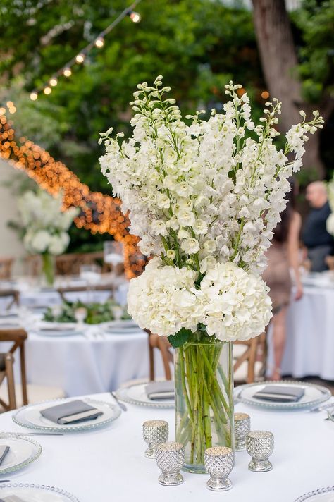 All white centerpiece of delphinium and hydrangea. Delphinium Wedding, Hydrangea Arrangements Wedding, Delphinium Bouquet, Hydrangea Centerpiece Wedding, White Hydrangea Centerpieces, Delphinium Flowers, White Flower Arrangements, Hydrangea Centerpiece, White Centerpiece