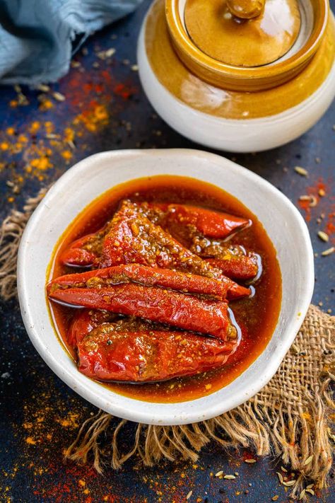 Bharwa Lal Mirch Ka Achar (Stuffed Red Chilli Pickle) is a traditional hot, spicy, tangy North Indian pickle made using thick red chilies and Indian pickling spices. I am sharing my mom's signature foolproof recipe to make this lal mirch ka bharwa achar (vegan). Mirch Ka Achar, Pickling Spices, Lal Mirch, Chilli Pickle, Methi Seeds, Pickling Spice, Nigella Seeds, Dried Mangoes, Powder Recipe