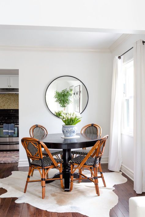 A petite dining situation is the perfect solution for this cozy two-bedroom. Here, classic French bistro chairs from Maison Midi surround a black Avalon round dining table from Crate & Barrel. Black Round Table, Black Round Dining Table, French Bistro Chairs, Round Chair, California Cool, Bistro Chairs, Modern Round, Round Table, Room Table