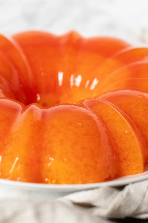 Retro orange sherbet jello salad with orange gelatin, orange sherbet and mandarin oranges, just like mom put on the holiday table every year. #thehungrybluebird #orangesherbetjello #mandarinorangesherbetjello #orangejellosalad #jellowithorangesherbet #sidedish #holidayside #comfortfood Mandarin Orange Jello, Orange Jello Salads, Mold Recipes, Jello Mold Recipes, Congealed Salad, Gelatin Salad, Jello Dessert Recipes, Jelly Shots, Orange Sherbert