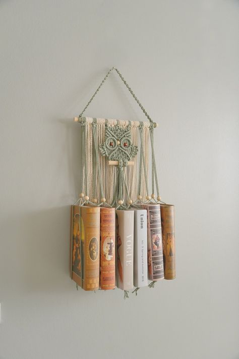 "Enhance your reading nook with our exquisite Macrame Book Holder featuring a charming Macrame Owl design. This unique and functional piece of room decor combines the elegance of macrame with the practicality of a hanging bookshelf. Perfect for the bohemian home, it adds a touch of mid-century modern style to your book storage while making a delightful gift for book lovers and best friends alike. This Macrame Book Holder is handcrafted/ hand woven with Natural Friendly Cotton Cord. DETAIL: Dimensions (taken without books): - Length: 24.8\"W ~ 62cm - Width: +  6 books: 14\" ~ 35cm + 8 books: 18\" ~ 45cm  + 10 books: 22\" ~ 55cm + 12 books: 26\" ~ 65cm NOTE: - NO books included. - The item is made to order, the listing photos are examples and the detail of actual products may vary a little b Macrame Hanging Book Holder, Handcrafted Home Decor, Macrame Book Shelf, Macrame Book Hanger, Diy Bookshelf Decor, Macrame Bookshelf, Unique Macrame Ideas, Macrame Book Holder, Functional Macrame