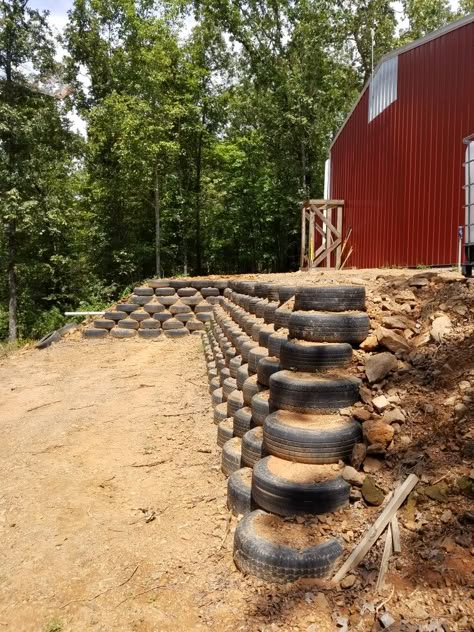 Tire Retaining Wall Landscape Design, Tire Yard Ideas, Tire Fence, Tire Wall, Cypress House, Diy Kids Playground, Tire Garden, Backyard Hammock, Eco Buildings