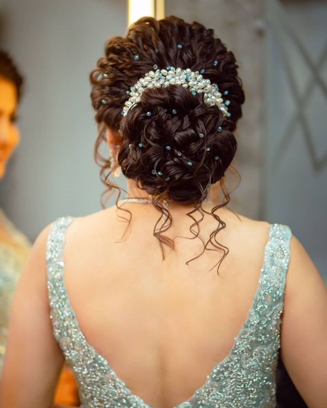 20+ Pearl-Adorned Bridal Hairstyles That You'll Love | WedMeGood Curly Hairstyles Indian Wedding Bun, Indian Bridal Hairdo With Flowers, Bun With Flowers Hairstyle, Hairbuns Hairstyles Indian, Indian Wedding Hairstyles Buns, Bridal Hair Buns With Flowers, Juda Hairstyle Buns, Floral Bun Hairstyle, Floral Hair Bun