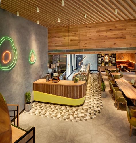 NAO | Avocado Tree Avocado Inspired Design, Interior Design, Radiating Ceiling Design, Colors of an Avocado, Avocado NEON Lights Avocado Cafe, Burrito Restaurant, Caffe Design, Burrito Bar, Small Cafe Design, Healthy Restaurant, Avocado Tree, Small Cafe, Cafe Interior Design