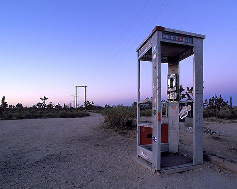 Sunrise. Mojave phone booth.   an isolated pay-phone located in a very remote part of California's Mojave desert, at least 30 miles from anywhere. It became famous when the phone number was posted on the internet. people would call from all over the world, just to see if the story was for real. other people would drive out and camp, answering the phone. Calls came from everywhere: Boston, NYC, Paris, Brussels, Berlin and Warsaw. the national park service ripped the phone out in 2001. Pay Phone Booth, Mojave National Preserve, Telephone Booth, Mojave Desert, Phone Booth, Old Phone, Roadside Attractions, Pay Phone, Phone Call