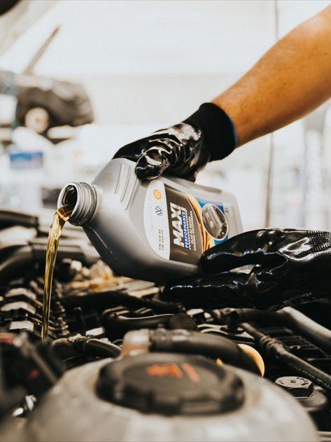 a person pouring oil into a car engine Car Mechanic Aesthetic, Mechanic Photography, Mechanic Photoshoot, Mechanics Photography, Oil Change Service, Car Oil Change, Mechanics Aesthetic, Automobile Advertising, Oil Service