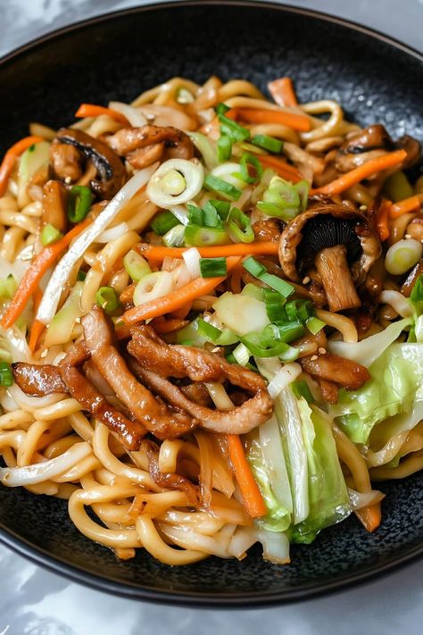 Quick and easy, yaki udon is sure to be a weeknight favorite! This Japanese dish features chewy udon noodles, tender meat, and crisp vegetables, all coated in a savory sauce. Udon Noodle Chicken, Yaki Udon Chicken, Recipes With Udon Noodles, Japanese Food Healthy, Udon Chicken, Japanese Recipe Ideas, Udon Noodle Recipe, Udon Stir Fry, Japanese Food Recipes